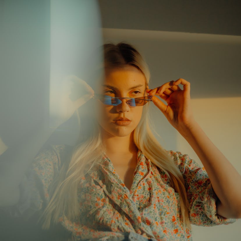 Young woman wearing rose-colored glasses the week of March 7, 2022, the worst for her unlucky zodiac...