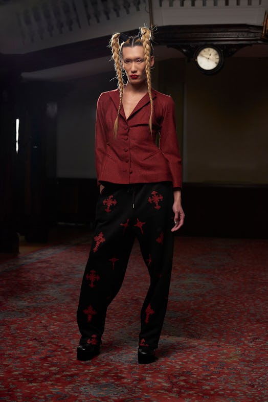 A model wearing a Lula Laora burgandy flannel and black pants with burgundy crosses, with pigtails a...