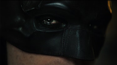 Robert Pattinson wearing the Caped Crusader's mask in The Batman