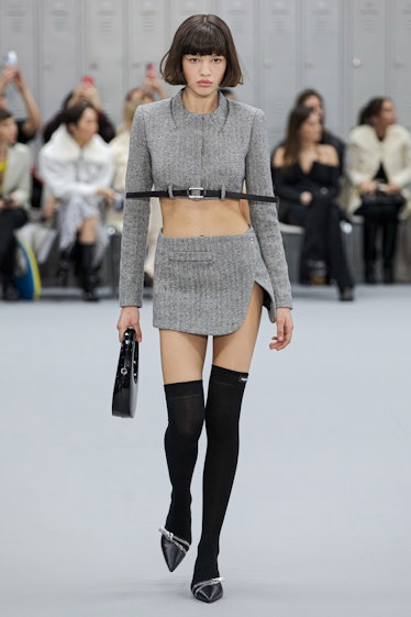 A model wearing an ensemble that exposes her midriff on the Coperni fall 2022 runway
