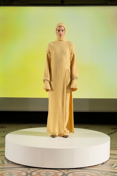 Model in yellow knit dress