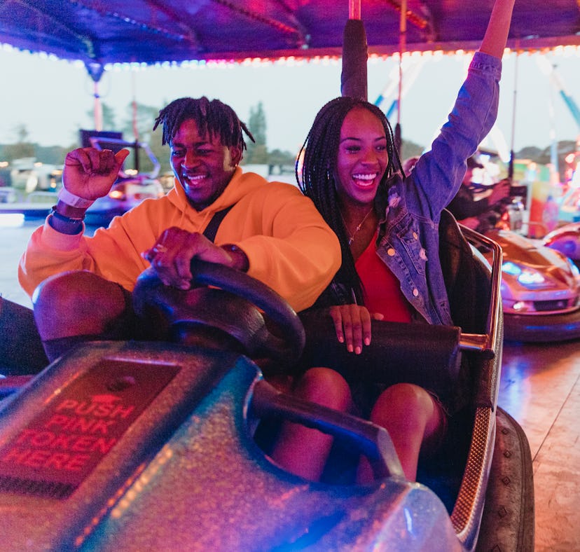 Young couple having fun in a bumper car the week of March 7, 2022, the best week for their lucky zod...