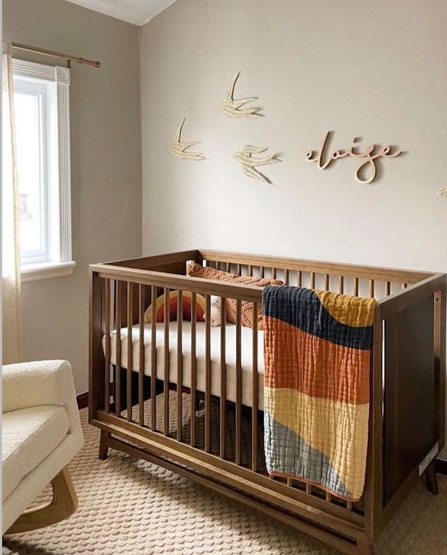 neutral baby nursery with wooden accents