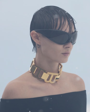 model with oversize black sunglasses and a gold interlocking b necklace at balenciaga paris fashion ...