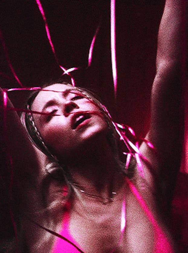 A still image from Euphoria showing Cassie dancing in a pink bathing suit amid pink streamers