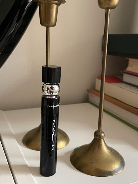 MAC Stack Mascara next to two golden candleholders