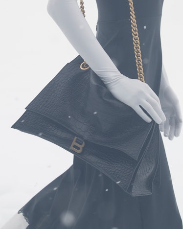 Balenciaga black purse and white gloves at paris fashion week