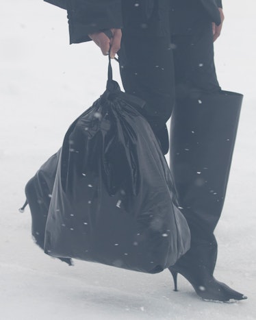 Black trash bag and oversize boots at Balenciaga paris fashion week