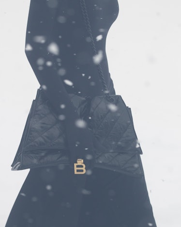 Balenciaga black purse with gold b buckle at paris fashion week