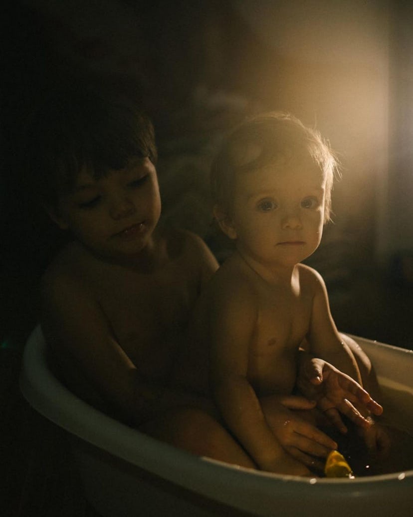 A mother and her little boy are bathed in light