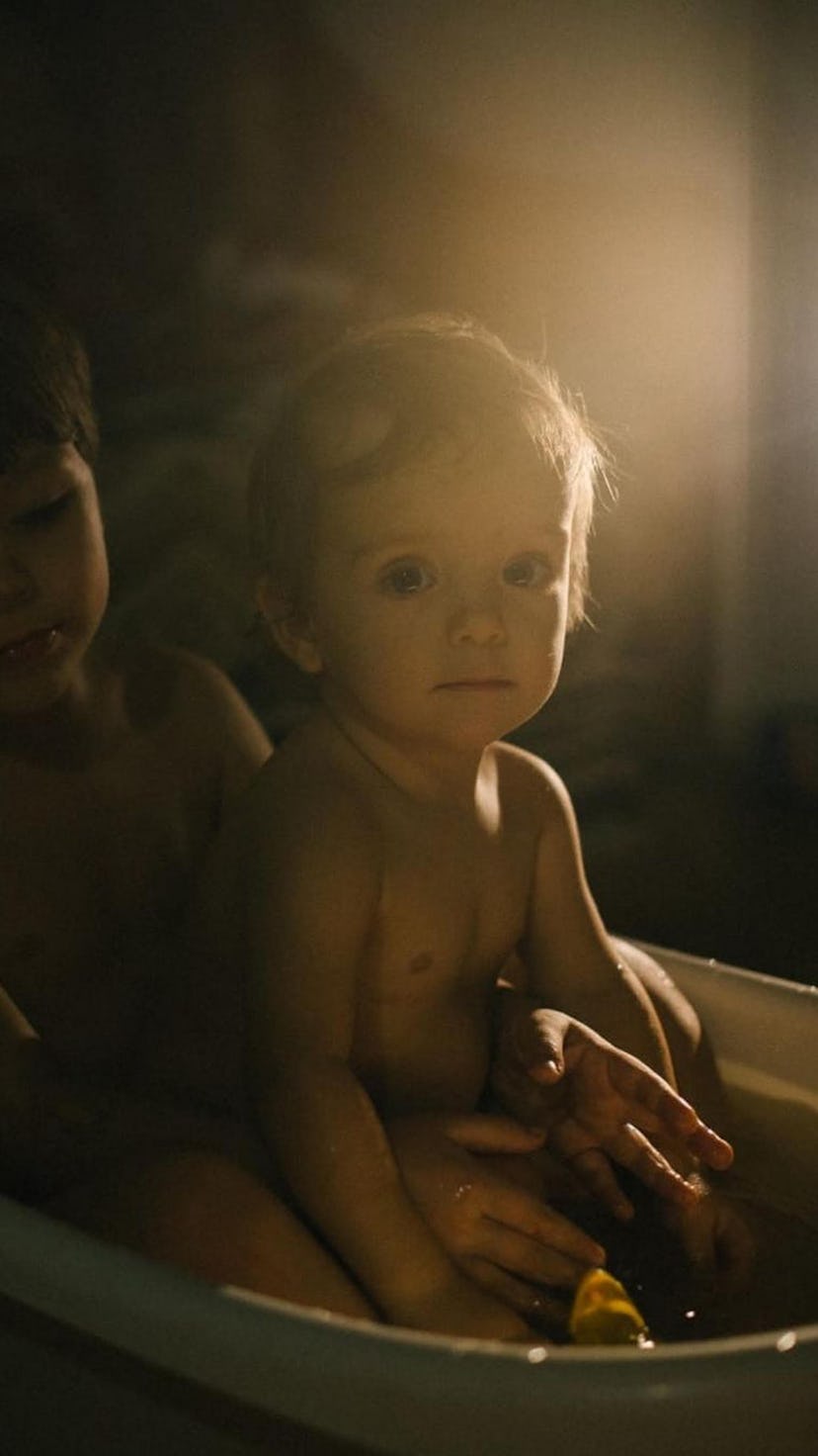A mother and her little boy are bathed in light