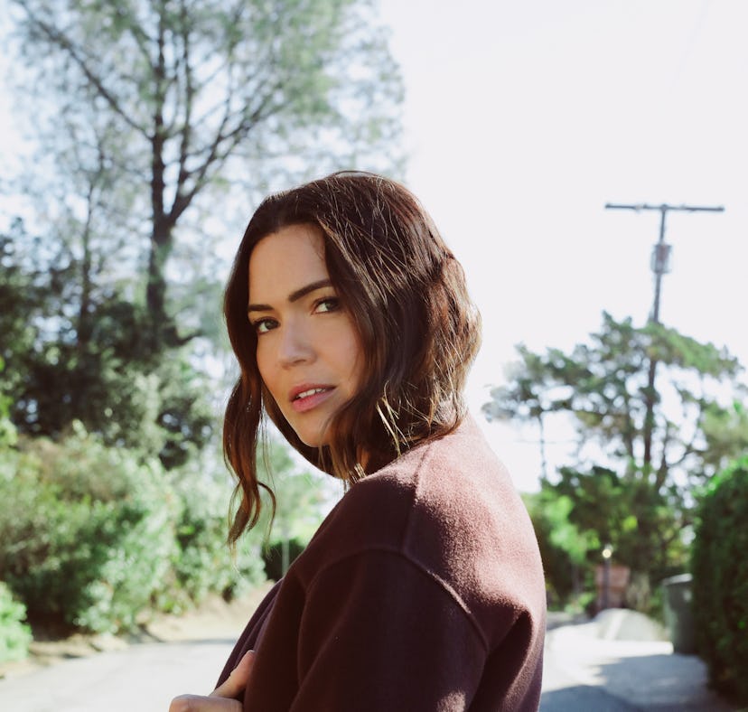 A promotional poster for Mandy Moore's new album, 'In Real Life,' which drops on May 13, 2022.