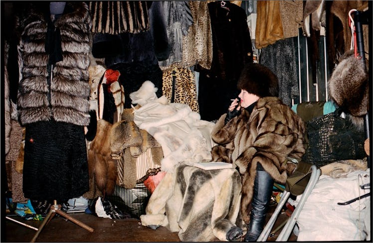 A photo of a person in a fur coat surrounded by furs by Fraser Thorne