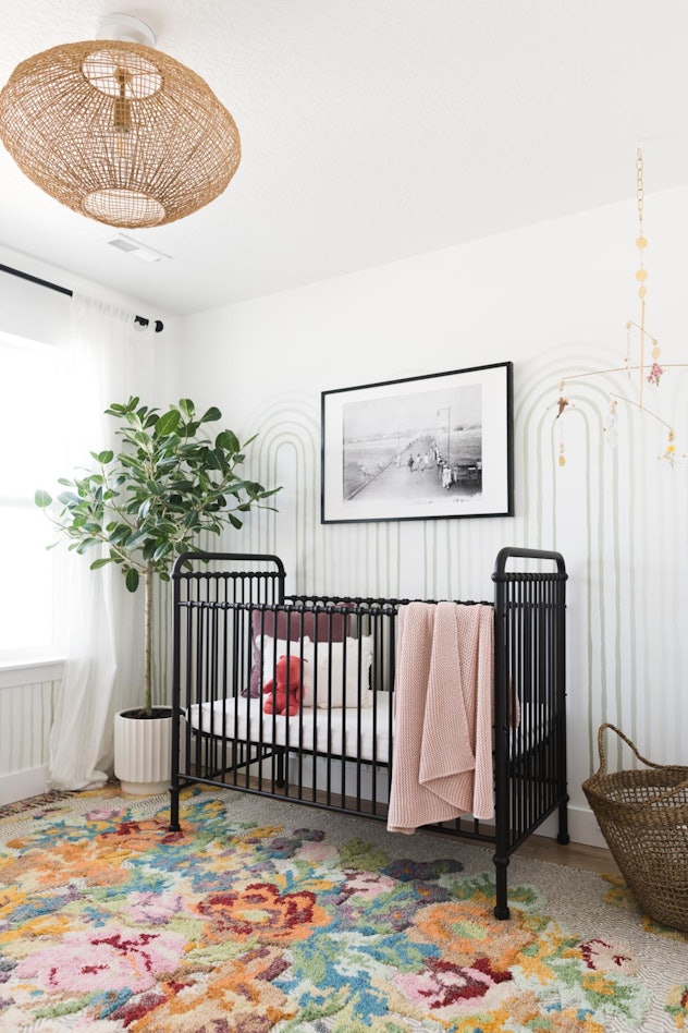 gender neutral baby nursery with handpainted wall paper