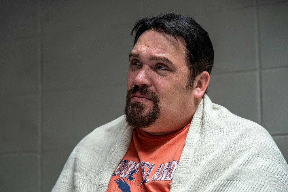 Glenn Fleshler as Russ Faria in NBC's The Thing About Pam, sitting in an interrogation room wearing ...