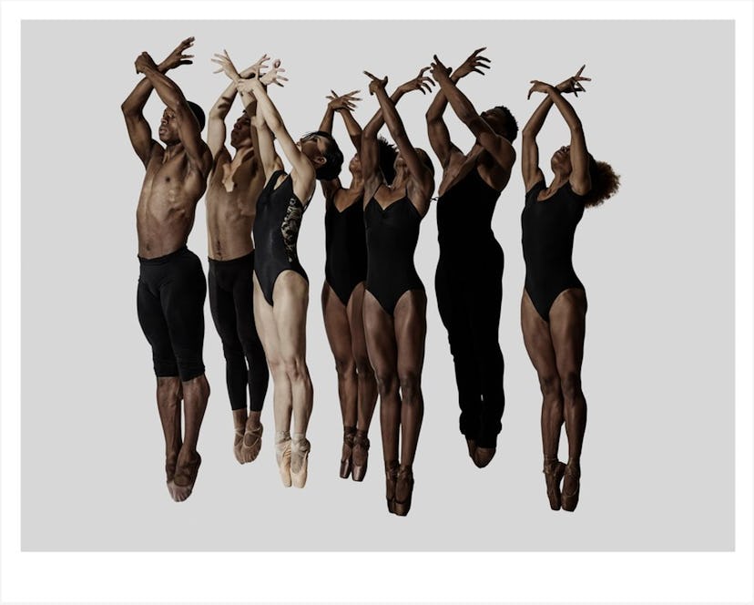 A photo of ballet dancers raising their arms by Rick Guest