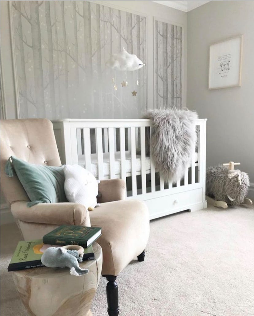 neutral baby nursery with birch tree wallpaper