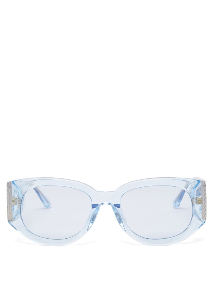 Linda Farrow blue acetate sunglasses pair with a trendy slit skirt