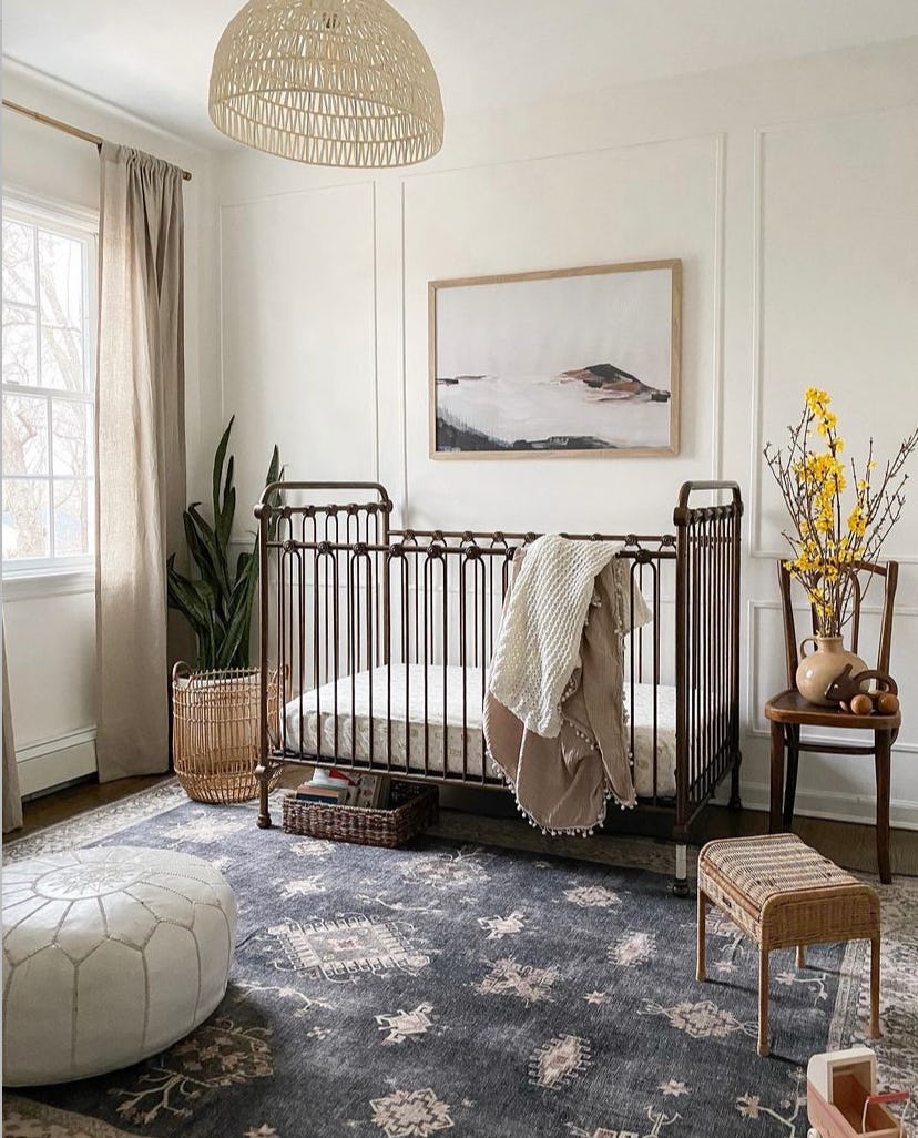 sophisticated neutral nursery with metal crib