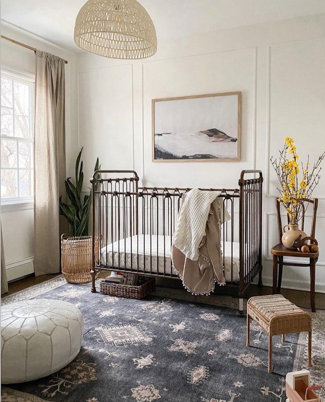 sophisticated neutral nursery with metal crib