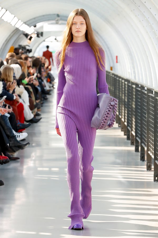 a model wearing a purple ribbed knit catsuit on the Stella McCartney runway