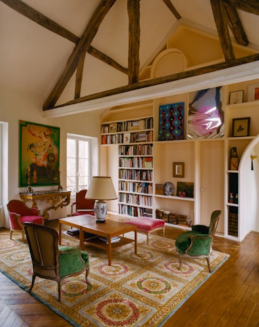 a formal living room filled with art and books