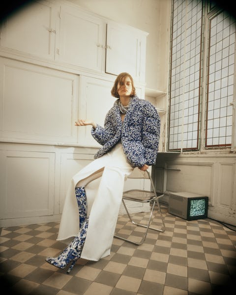 a model wearing a blue printed puffer coat and white maxi skirt by Dries Van Noten