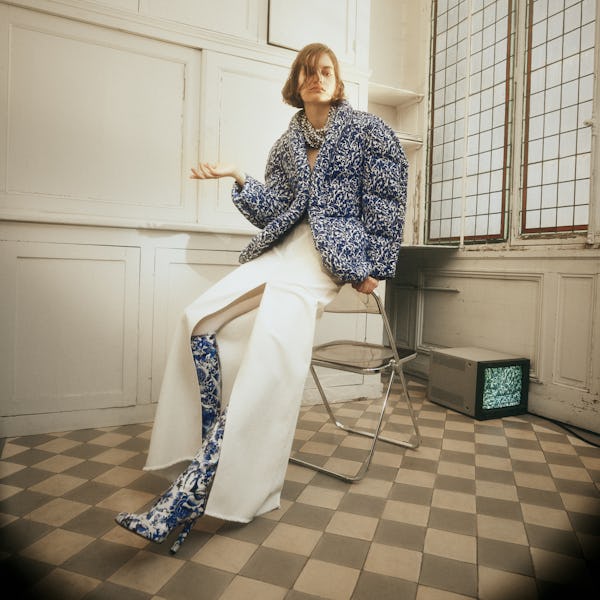 a model wearing a blue printed puffer coat and white maxi skirt by Dries Van Noten
