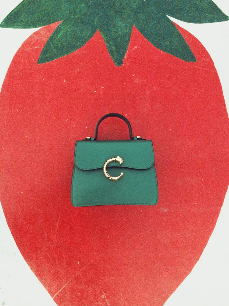 Green bag with illustration of strawberry.