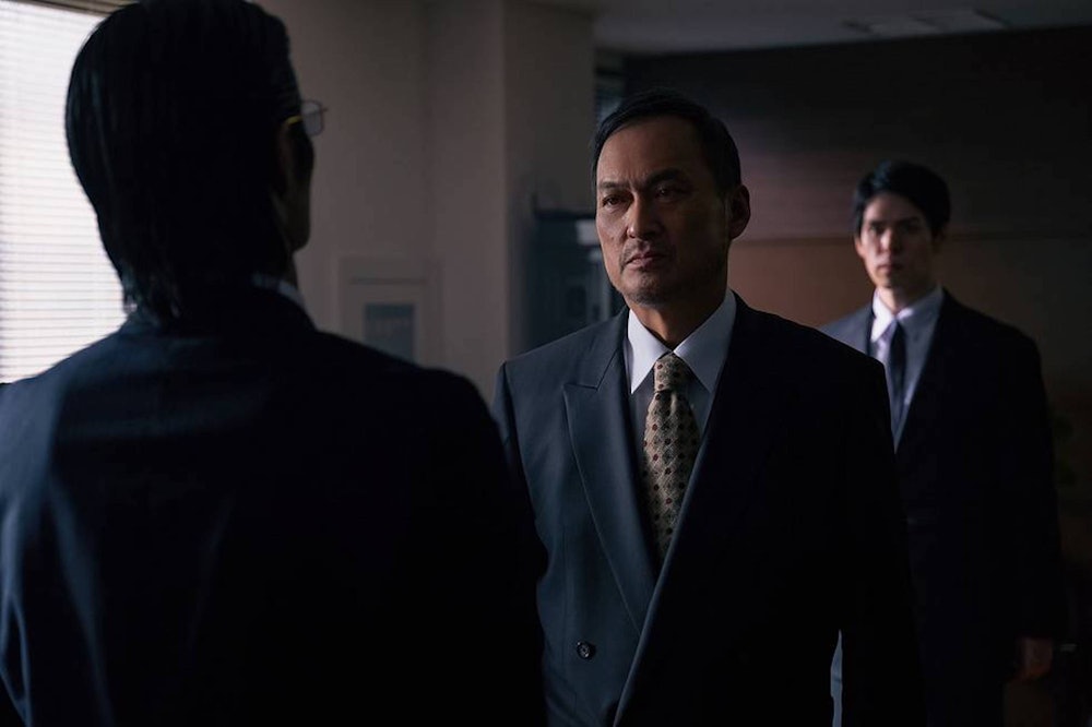 Ken Watanabe standing in front of a yakuza henchman in HBO Max’s Tokyo Vice
