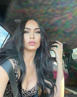 The actress poses for a selfie in her car