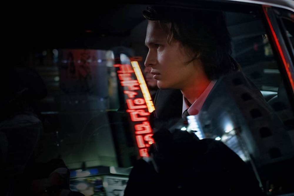 Ansel Elgort sits in a car as Jake Adelstein in Tokyo Vice