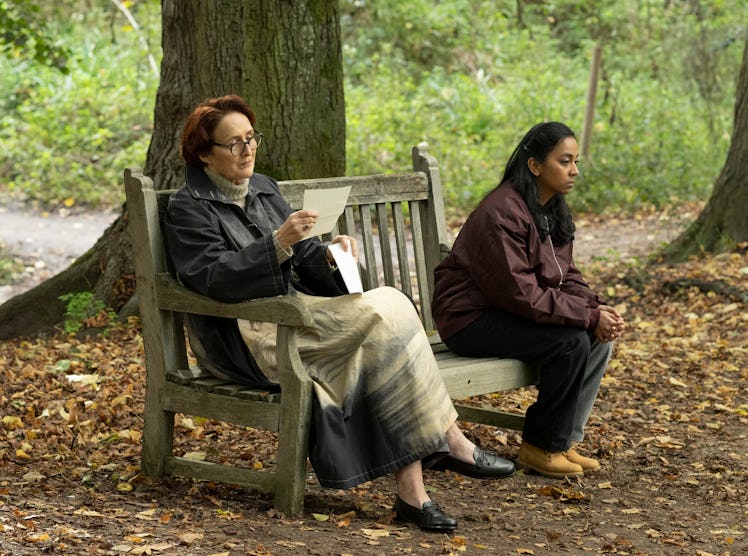 Carolyn reading a letter while sitting on a bench with Pam in the Killing Eve season 4 finale