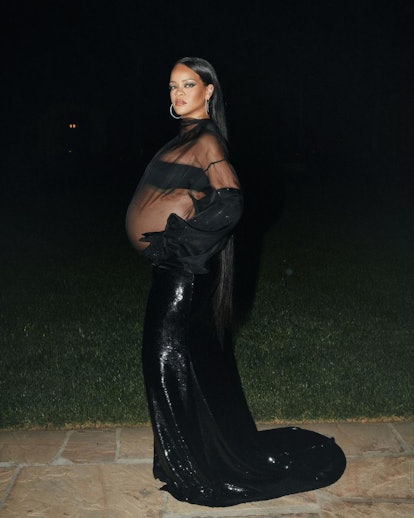A pregnant Rihanna wearing a sheer black gown