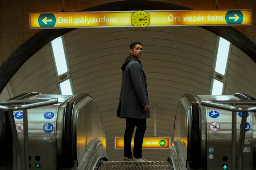 Alan (Charlie Barnett) standing on the escalator at the subway station in Russian Doll Season 2.