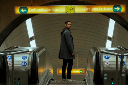 Alan (Charlie Barnett) standing on the escalator at the subway station in Russian Doll Season 2.