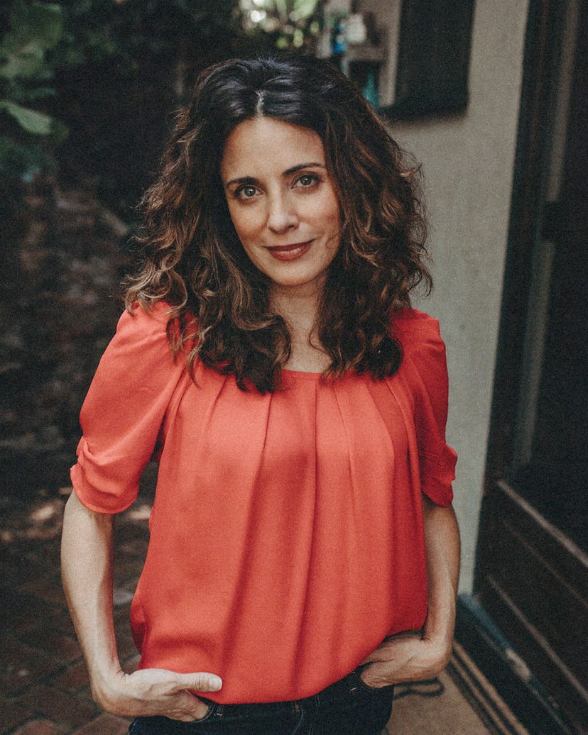 Alanna Ubach wearing a red shirt