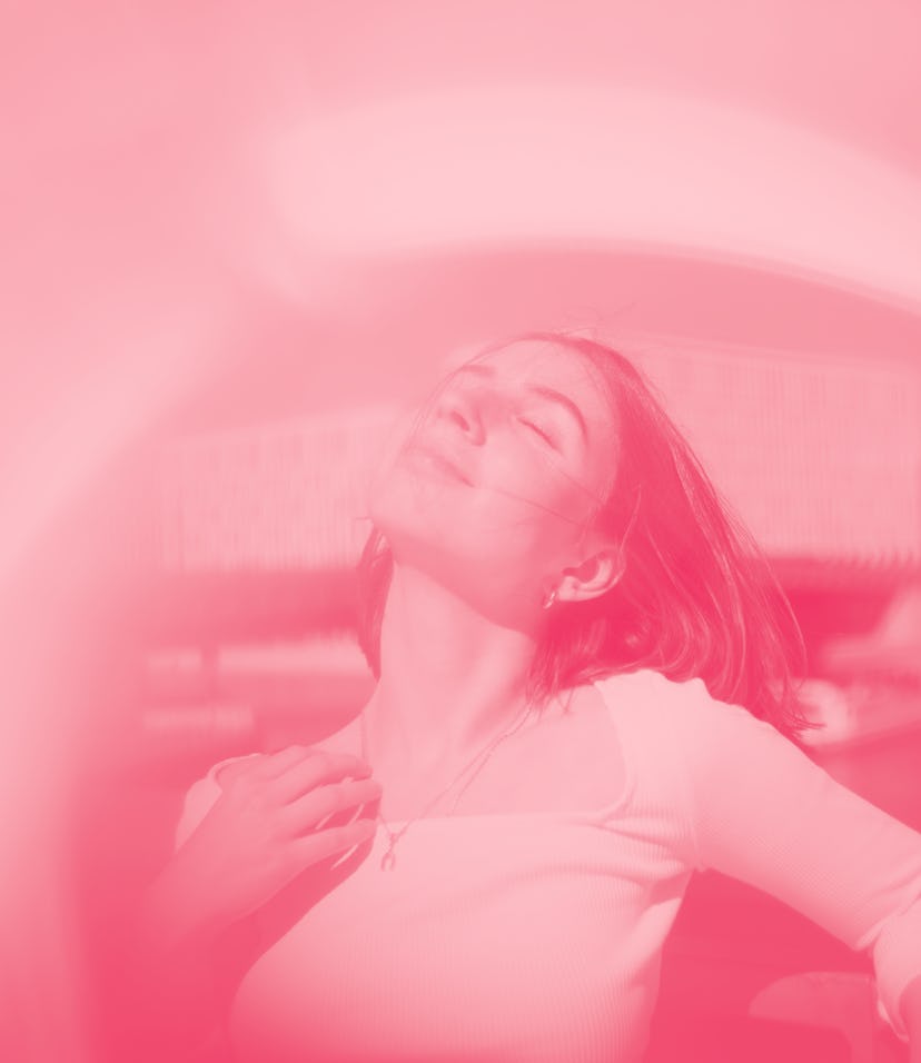 Young woman looking up during the 2023 full pink moon, which isn't actually pink.