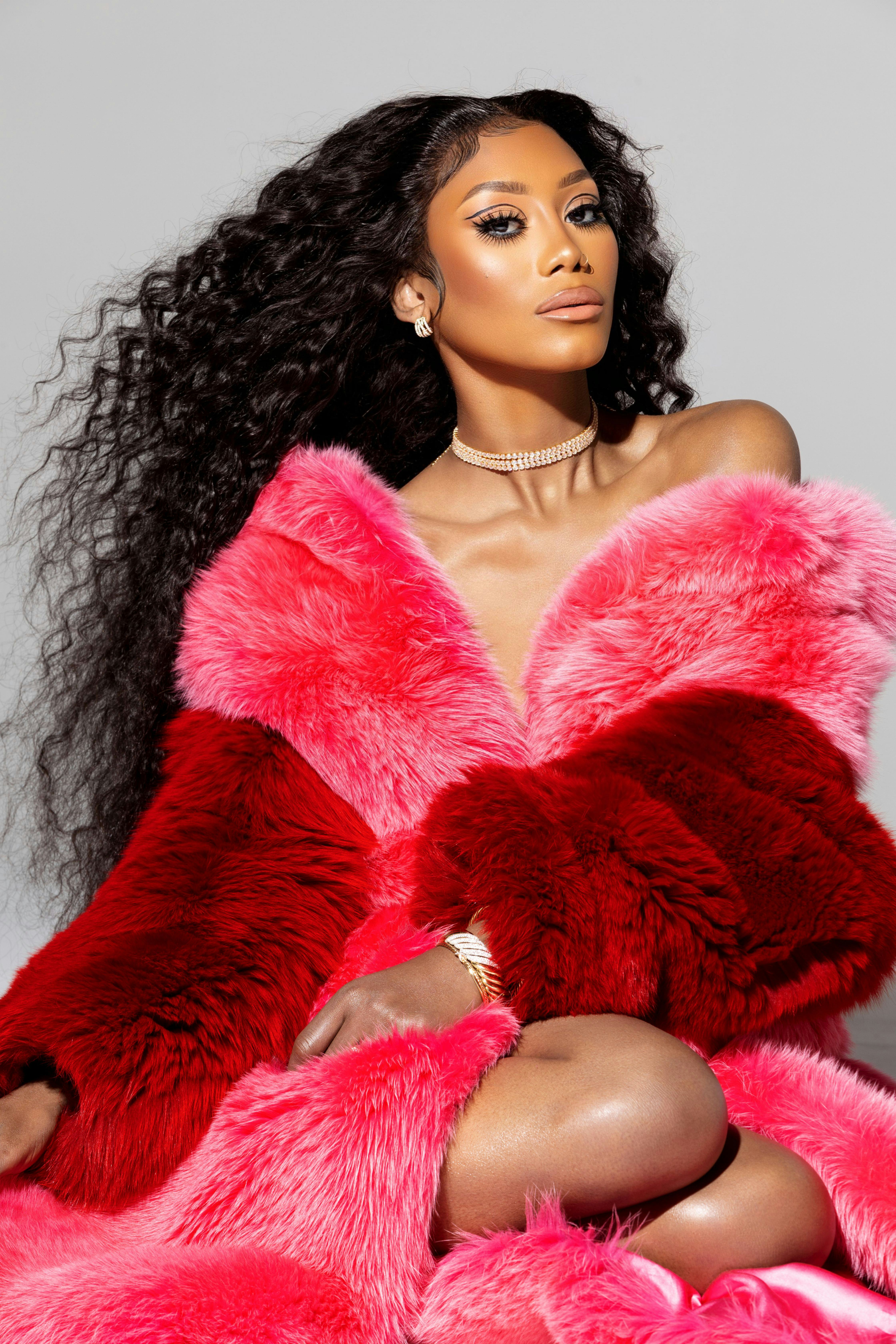 A model wearing combination of pink and red fur 