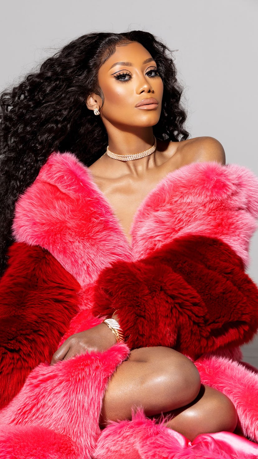 A model wearing combination of pink and red fur 