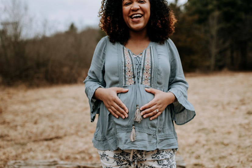 pregnant women laughing thinking of pregnancy riddles