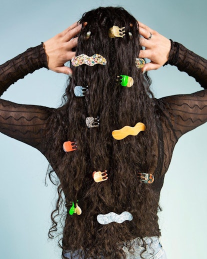 Back of women's head with her long curly black hair covered in Chunks clips