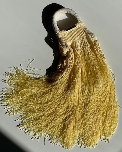 a yellow crochet fringe bag