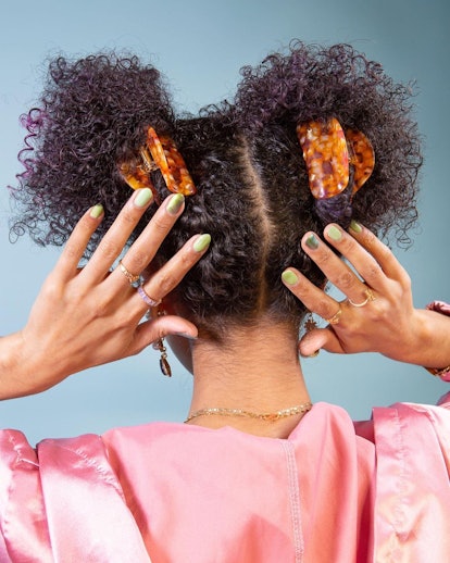 Back of woman's head with hair in buns adorned with Chunks claw clips