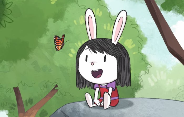 Elinor the curious rabbit sits on a rock looking at a butterfly in the new movie 'Elinor Wonders Why...