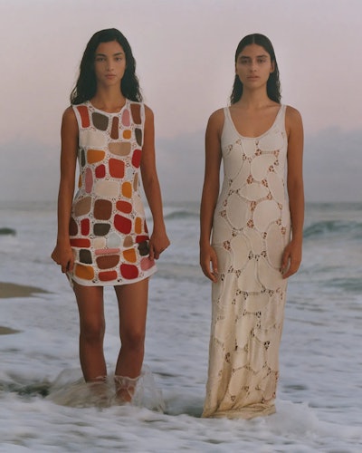 two models wearing summer dresses by Chloe on the beach