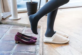 woman taking off pumps and putting on slippers