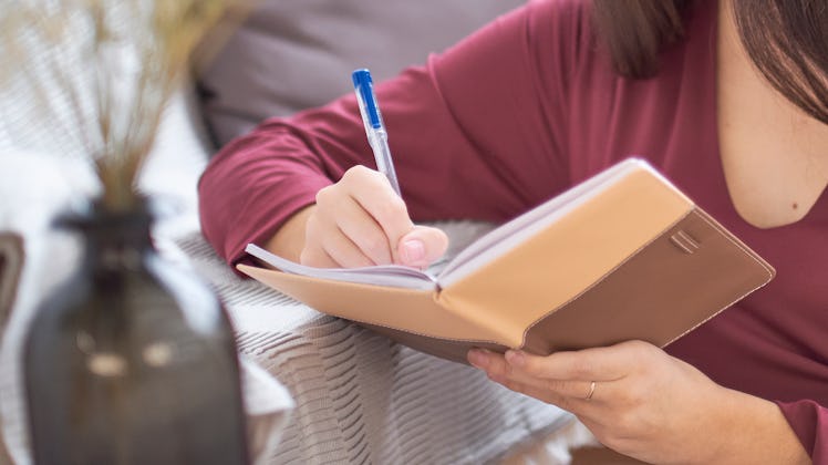 woman writing in a notebook