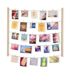 Some good college graduation gifts include this hanging photo display for polaroids.