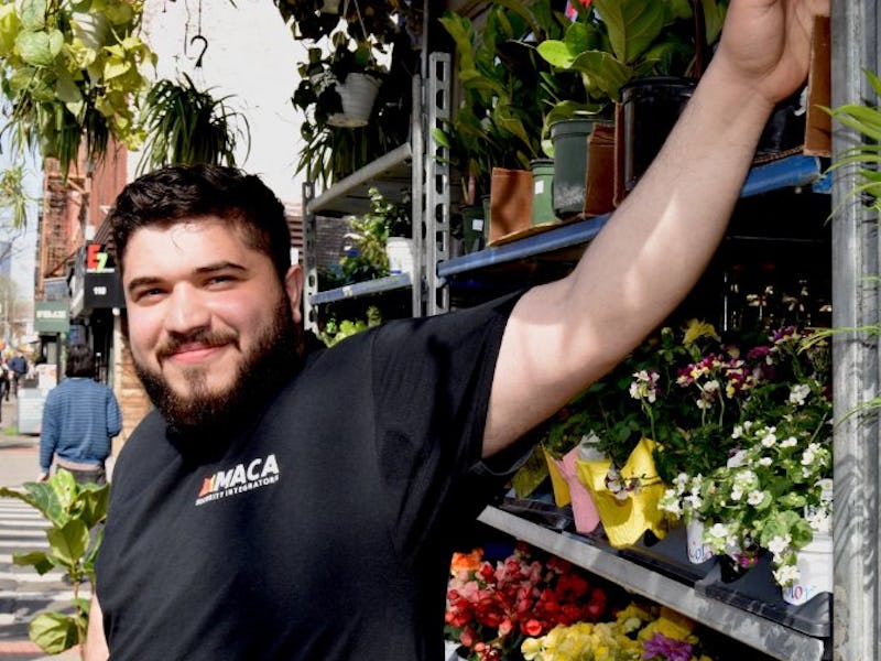 Zack Tahhan pictured standing in front of a storefront flower display